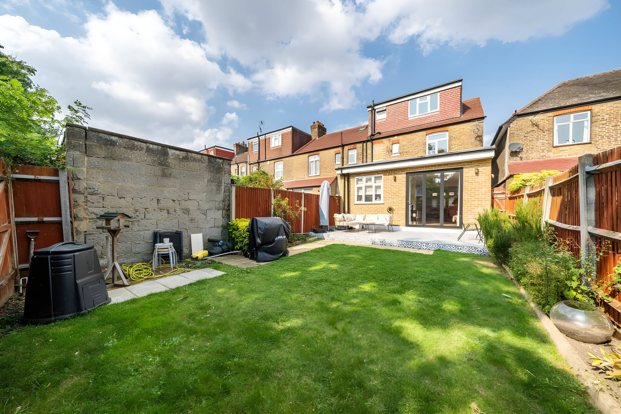 Completed rear extension viewed across a green garden