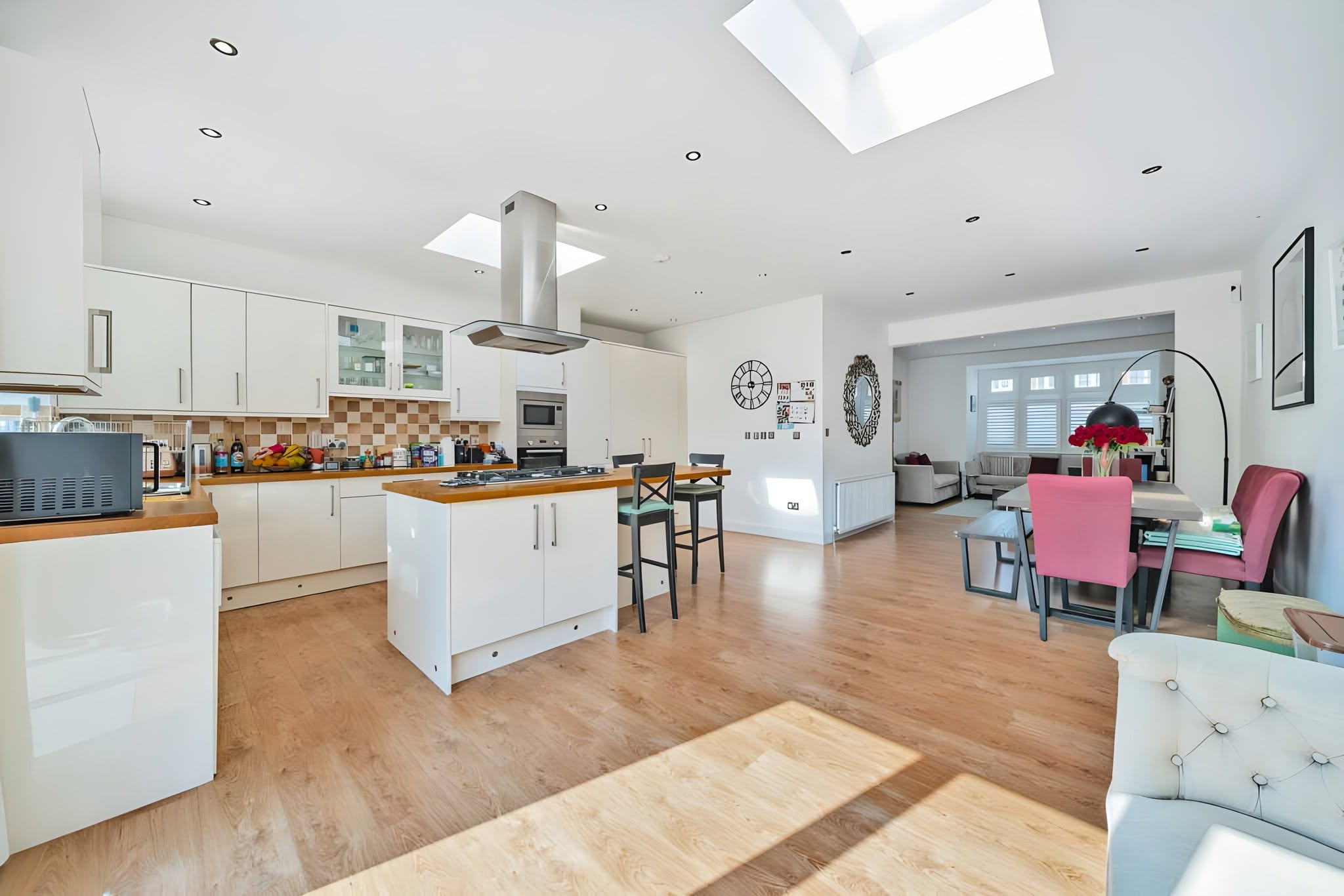 Completed open-plan kitchen with a central island and skylight