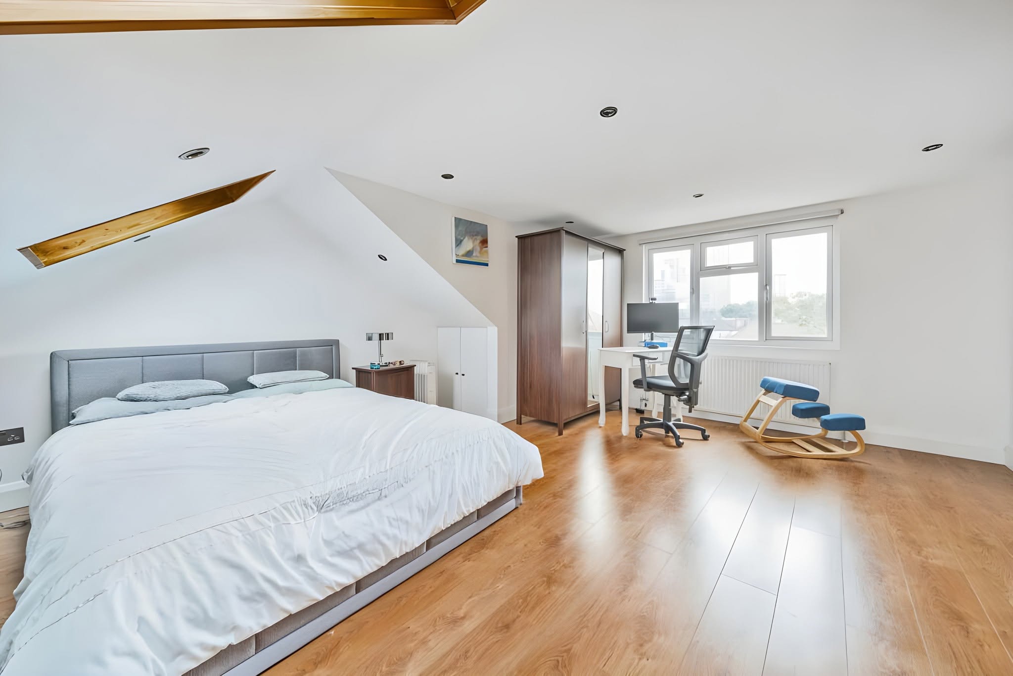 Bright completed loft bedroom with timber flooring